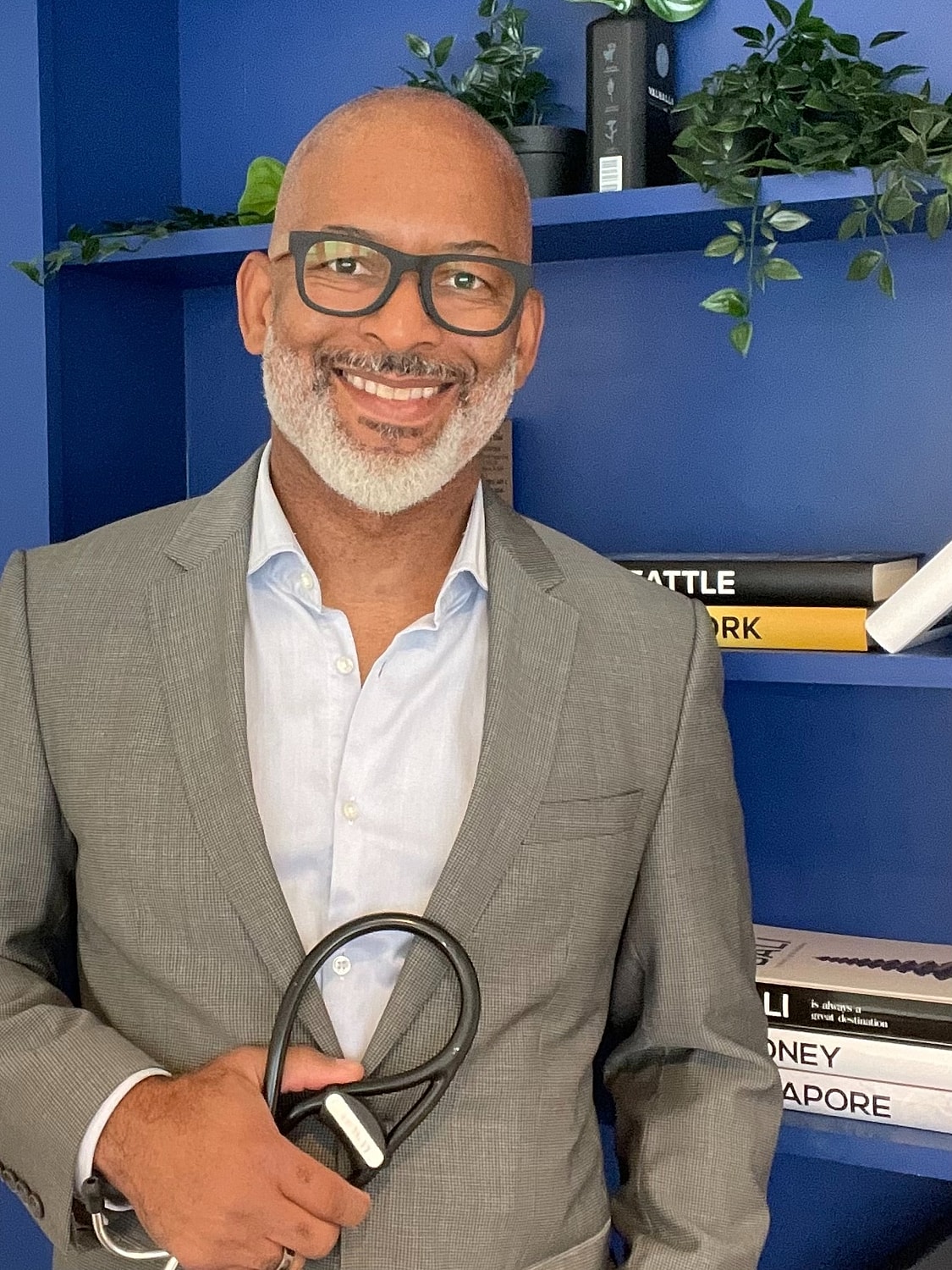 Smiling man wearing a suit against a white background.