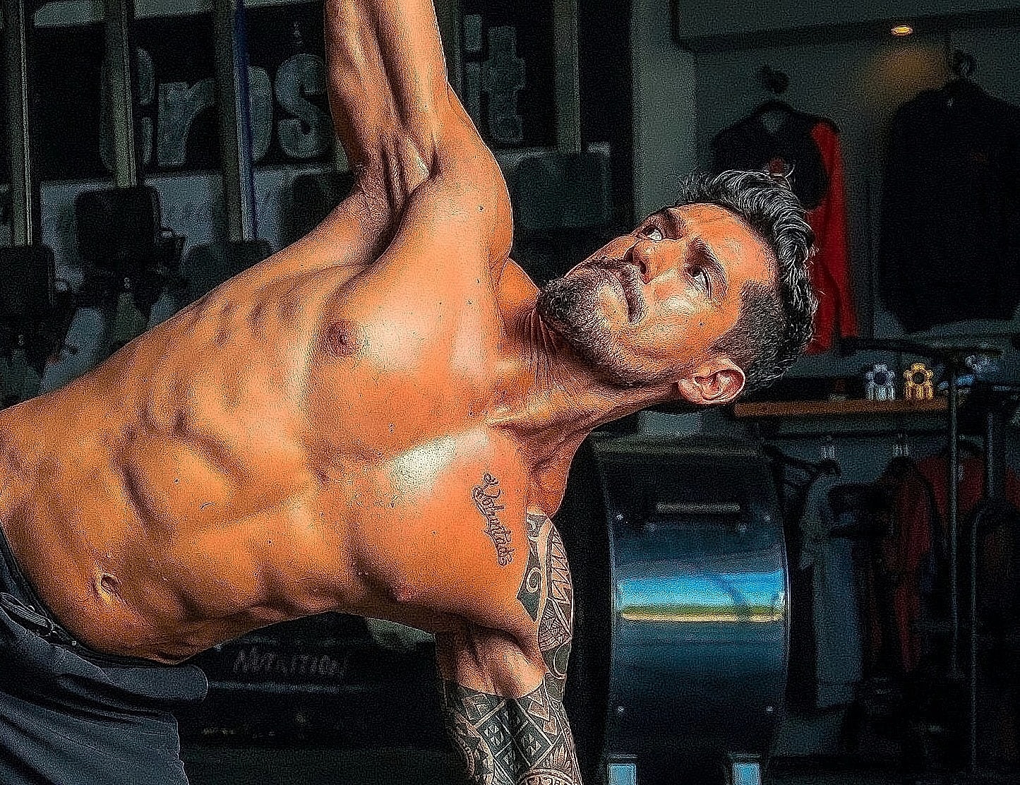Man performing kettlebell exercise in gym.