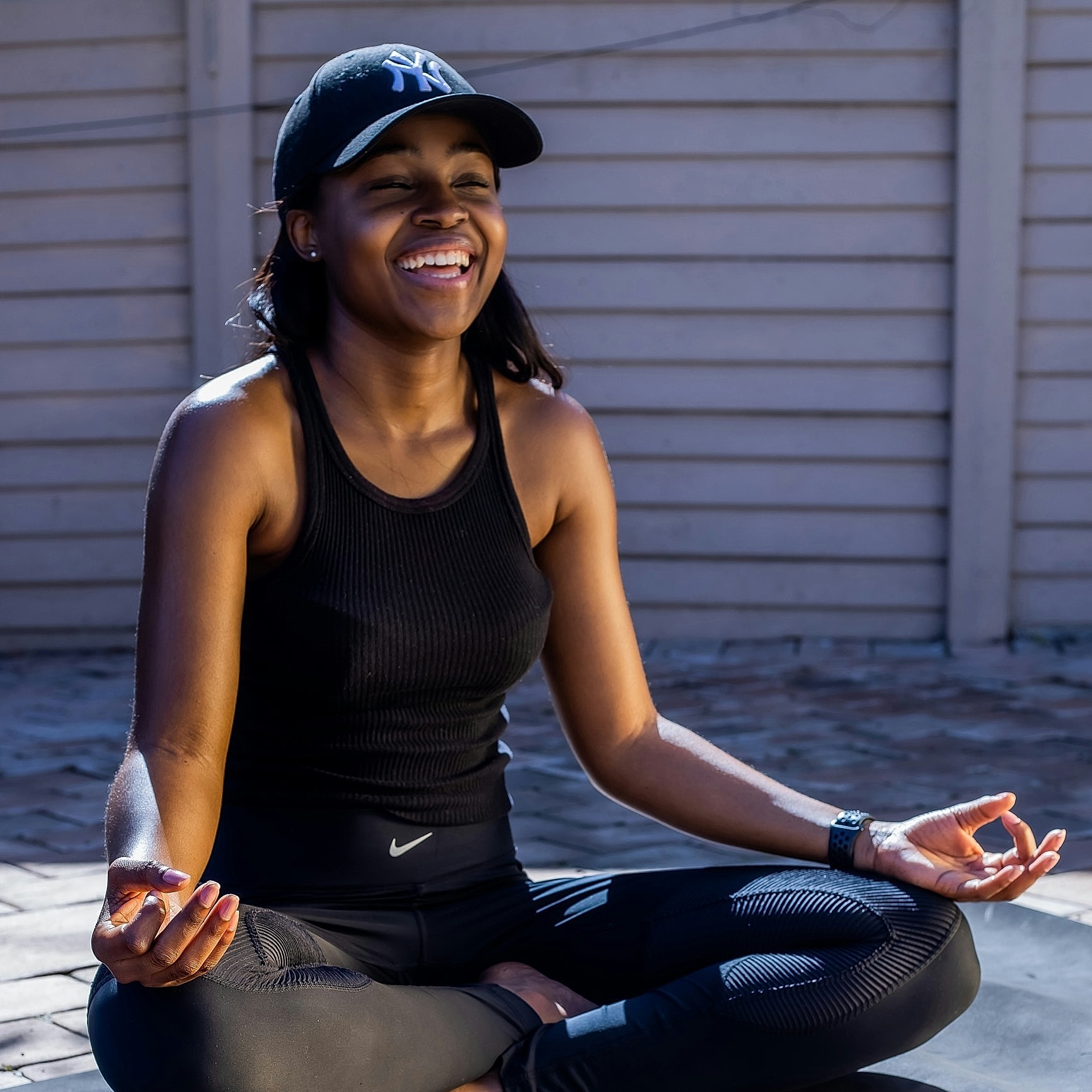 Person meditating during sunset in serene environment.
