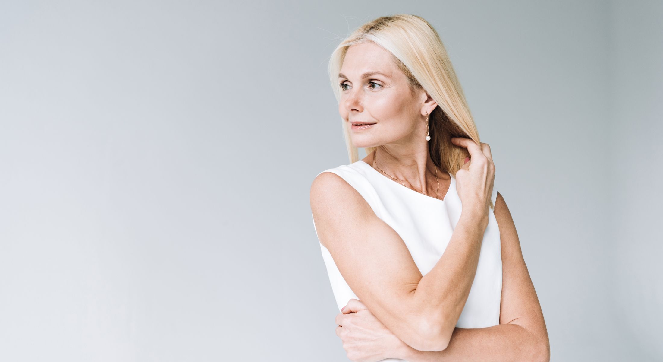 blonde woman standing in front of white background